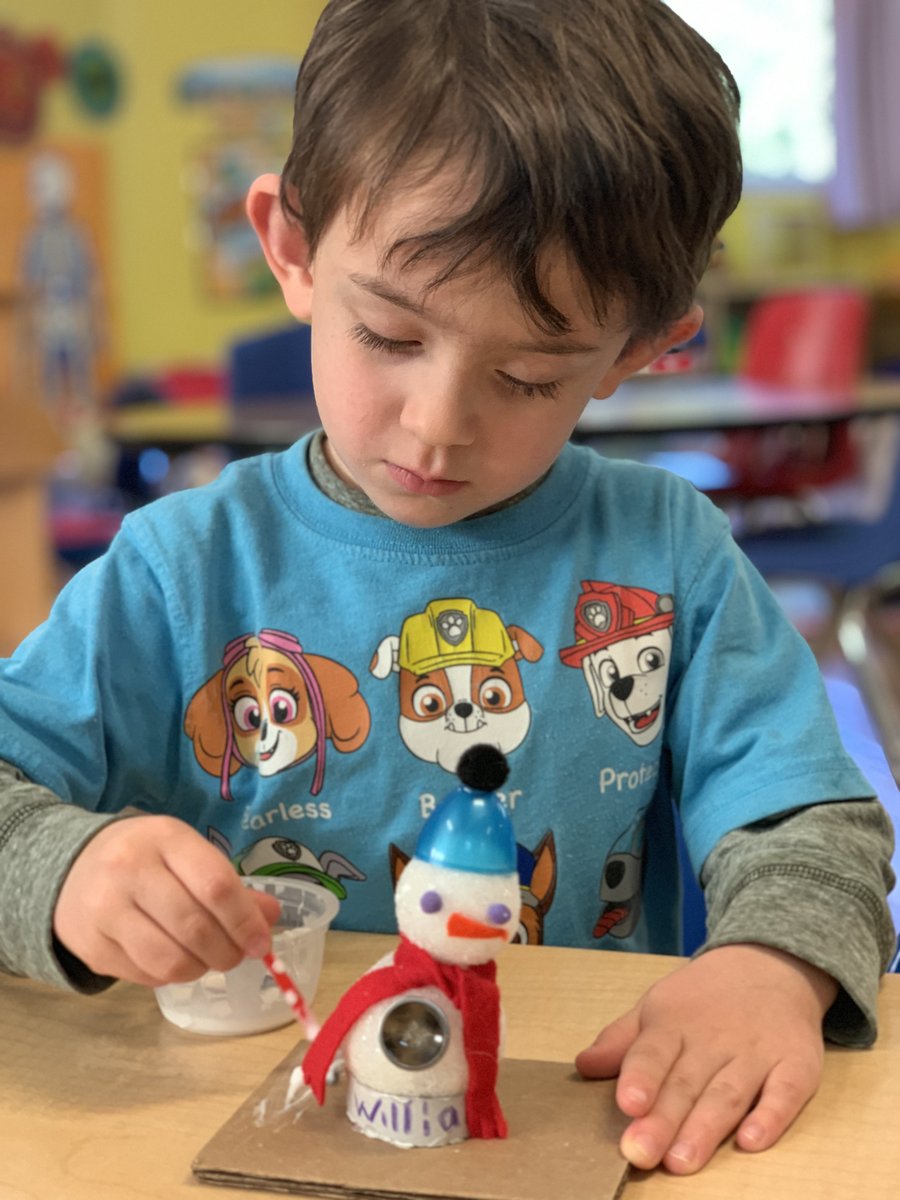 Child working on a winter snowman craft at Butterflies Academy